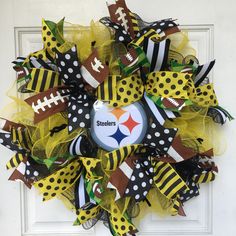 a yellow and black mesh wreath with a football on the front, polka dot dots