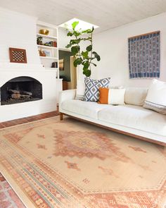 a living room filled with furniture and a fire place in the middle of the room