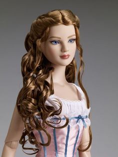 a doll with long hair wearing a pink dress