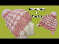 a crocheted hat with two pom poms on top and the words gorro tejo a crochet below it