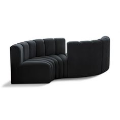 a black couch sitting on top of a white floor