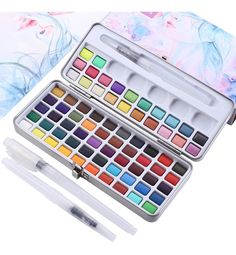 the watercolor paint set is open and ready to be filled with it's contents