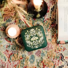 an open book and some candles on a table