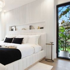 a white bedroom with black and white decor