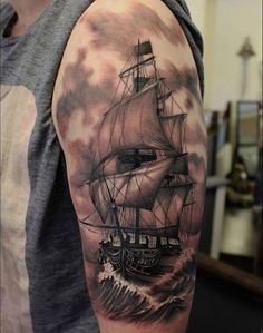 a man with a ship tattoo on his arm