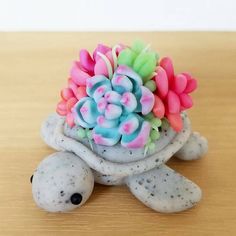 a toy turtle with flowers on it's back