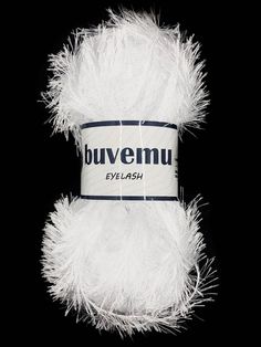 a white fluffy ball of yarn on a black background