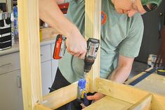 a man is working on some wood in his home workshop with drill and screwdrivers