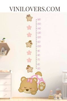 a child's growth chart with teddy bears and stars on it, in the corner of a room