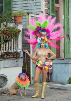 a woman in a colorful costume standing next to a dog