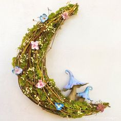 the moon is made out of moss and flowers