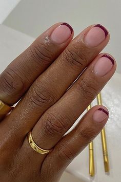 While the timeless nude and white colourway will always be classy, burgundy French tip nails are this season's must-have look... Burgundy Tipped Nails, Pink And Burgundy French Nails, Short Nail Inspo Winter 2024, Nude Nails With Minimal Design, French Manicure Burgundy, Nail Inspo For Very Short Nails, Beautiful Simple Nails, Short Color French Nails, Nails For 2024 Winter