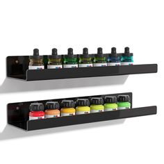 two black shelfs with different colored bottles on them