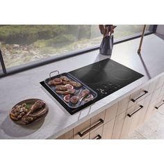 a stove top oven sitting on top of a counter next to a bowl of food