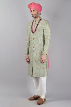 Light green printed sherwani with floral motifs in gota patti and zardosi embroidery. Paired with off white churidar and embroidered dupatta.
Component: 3
Pattern: Printed,Embroidered
Type Of Work: Floral
Neckline: Mandarin
Sleeve Type: Full Sleeves
Fabric: Raw Silk
Color: Green
Other Details: 
Floral motifs
Front buttons
Note: Head accessory, stole and neckpiece worn by the model is not for sale
Occasion: Groom, Wedding - Aza Fashions White Churidar, Zardosi Embroidery, Types Of Work, Luxury Sale, Churidar, Head Accessories, Raw Silk, Festival Wear, Full Sleeve