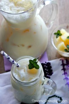 two glasses filled with milk and some fruit