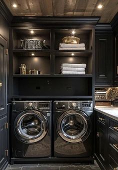 a washer and dryer in a room with dark wood paneling on the walls