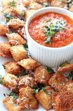 small appetizers with tomato sauce and parmesan bread croutons on a plate