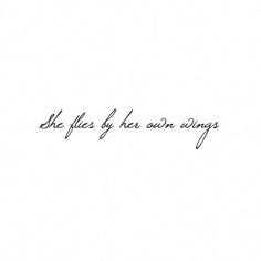 the words she flies by her own wings are written in cursive handwriting on white paper