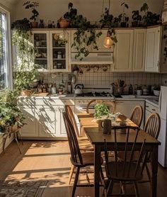 a kitchen filled with lots of wooden furniture and potted plants on top of the cabinets