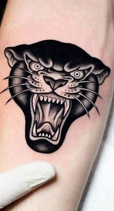 a black panther tattoo on the arm