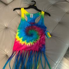 a tie - dyed shirt with blue, yellow and pink fringes on the bottom