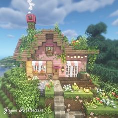 a small pink house surrounded by greenery and flowers