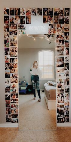 a woman standing in front of a mirror with many pictures on it