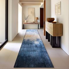 a blue rug is in the middle of a hallway