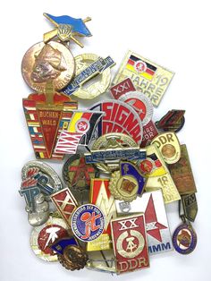 a pile of different colored and shaped badges