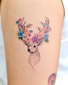 a deer with flowers in its antlers on the thigh