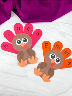 two paper turkeys with words on them