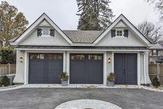 a house with two garages and three windows