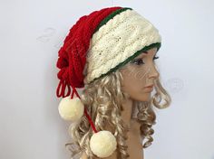 a mannequin head wearing a knitted hat with pom - poms