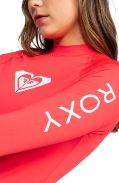 Spend a day in the waves wearing this protective rashguard styled with a high neckline and a sporty logo design. 24 1/2" length (size Medium)   Mock neck   Long sleeves   86% recycled polyester, 14% elastane   Hand wash, line dry   Imported Sporty Surfing Rash Guard With Thumbholes, Sporty Rash Guard With Thumbholes For Surfing, Sporty Rash Guard With Uv Protection For Sports, Fitted Rash Guard For Sports, Sporty Rash Guard With Crew Neck For Water Sports, Sporty Rash Guard For Water Sports With Crew Neck, Fitted Athleisure Rash Guard For Water Sports, Sporty Crew Neck Rash Guard For Water Sports, Sporty Rash Guard With Uv Protection For Water Sports