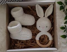 a crocheted bunny and booties in a box