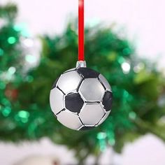 a soccer ball ornament hanging from a christmas tree