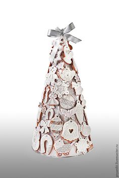 a christmas tree made out of cookies on a white background with silver ribbon and bow