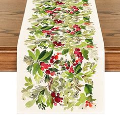 a table runner with holly and berries on it