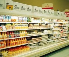 an aisle in a grocery store filled with lots of juices and condiments