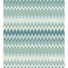 a blue and green rug with wavy lines