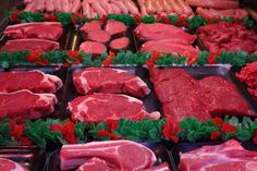 raw meats are displayed in trays on display