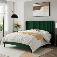 a bedroom with a green headboard and white bedding