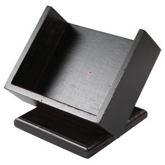 an empty wooden box sitting on top of a black stand with silver foil covering it