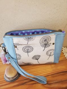 a blue and white purse sitting on top of a wooden table