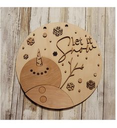 a wooden sign that says, let it snow with an image of the moon and trees