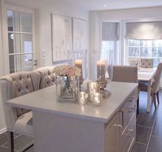 a white kitchen island with candles on it