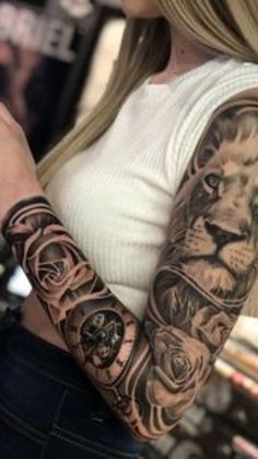 a woman with a lion tattoo on her arm