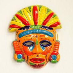 a colorful mask hanging on the wall