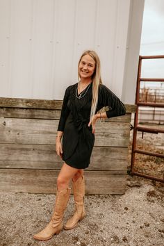 The LBD is a party staple. But the LBWD is a Vegas staple. Our Black Hills Dress (aka the Little Black Western Dress) pairs stretchy faux suede material with playful fringe and the result is as ready for those post-rodeo celebrations as you are. FEATURES Fringe detail Wrap dress MATERIAL 90% Polyester, 10% Elastane Stretch faux suede 10047249 Black Western Dress With Boots, Western Boots Black Dress, Western Glam Outfit Plus Size, Western Black Dress Outfit, Black Leather Dress Western Outfit, Black Dress With Cowgirl Boots, Western Gala Outfit, Black Western Dress, Black Dress With Western Boota